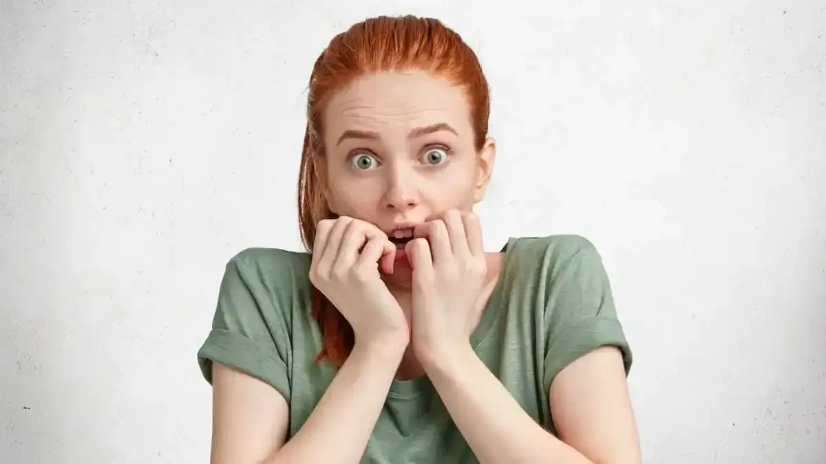 Anxious young woman reacting with fear, representing how EFT tapping therapy helps overcome fear and anxiety.